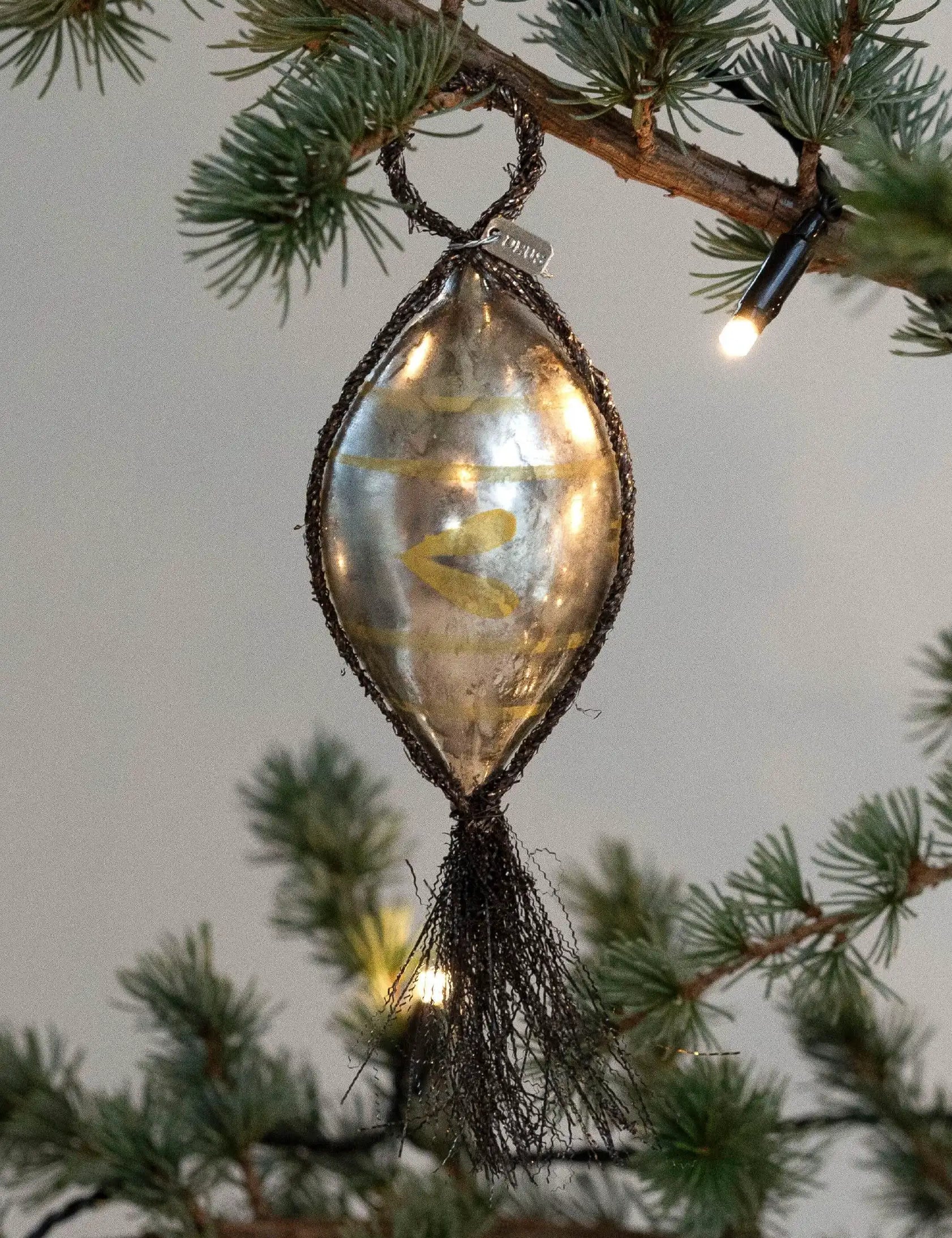 Glass_Bauble_with_Tinsel_and_Handpainted_Decorations.webp