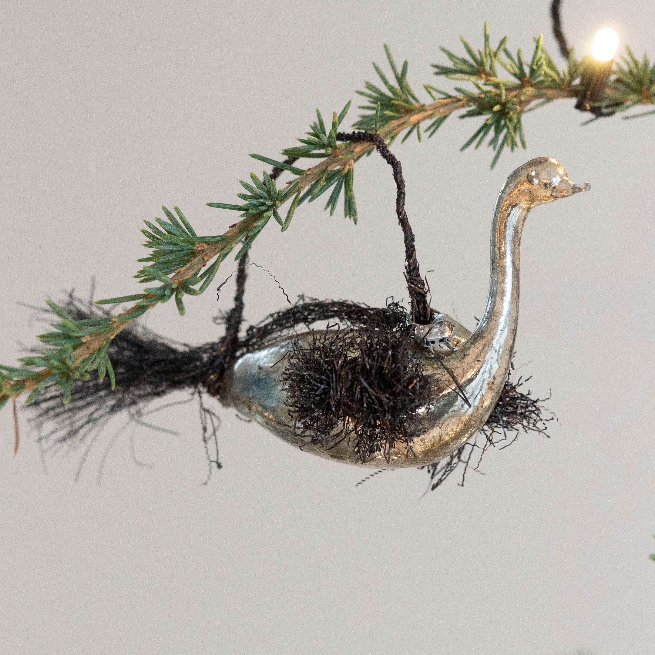 silvered-glass-bird-with-tinsel-decorations-591711.jpg